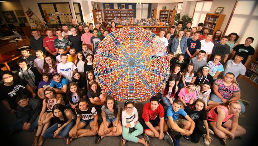 琳达Dodd-Nagel, 她八年级的数学学生, Tae库克, and 克里斯。希尔 surround the runcitruncated hypericosahedron